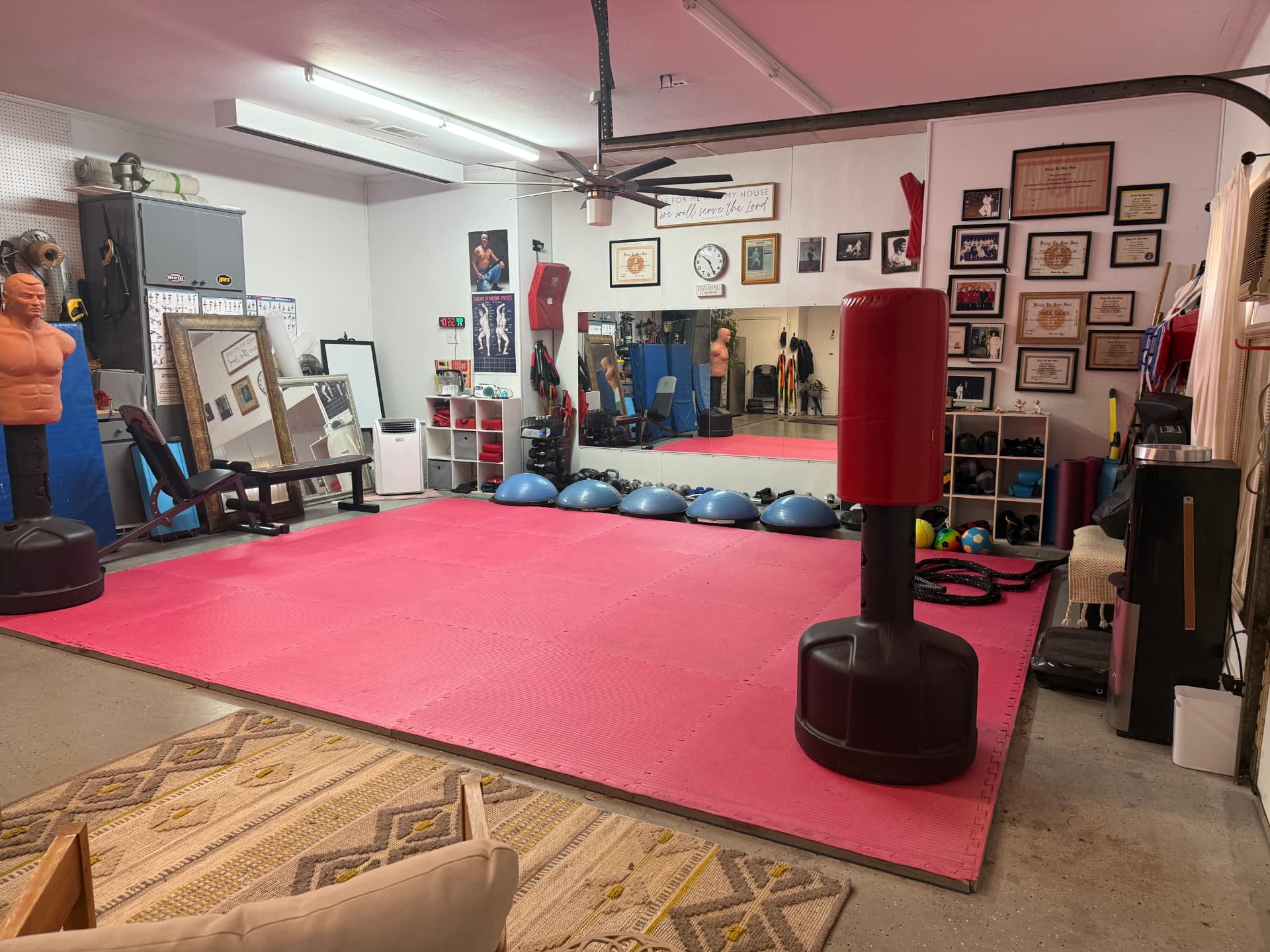 Inside the home studio in Heath, TX, with red mats, training equipment, and framed certificates